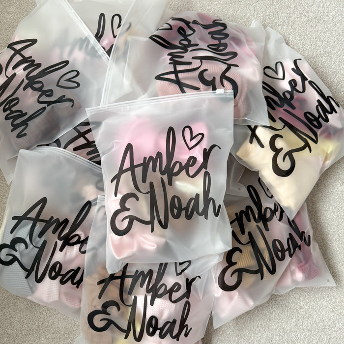 Assorted bow packs in clear plastic pouches with 'Amper & Noah' script.