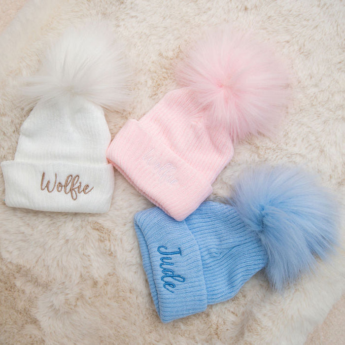 Baby rib-knit pom hats: white โWolffieโ and light blue โJunoโ, with pom poms
