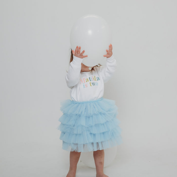White personalised birthday sweater with multicolor 'Matilda is two' text print