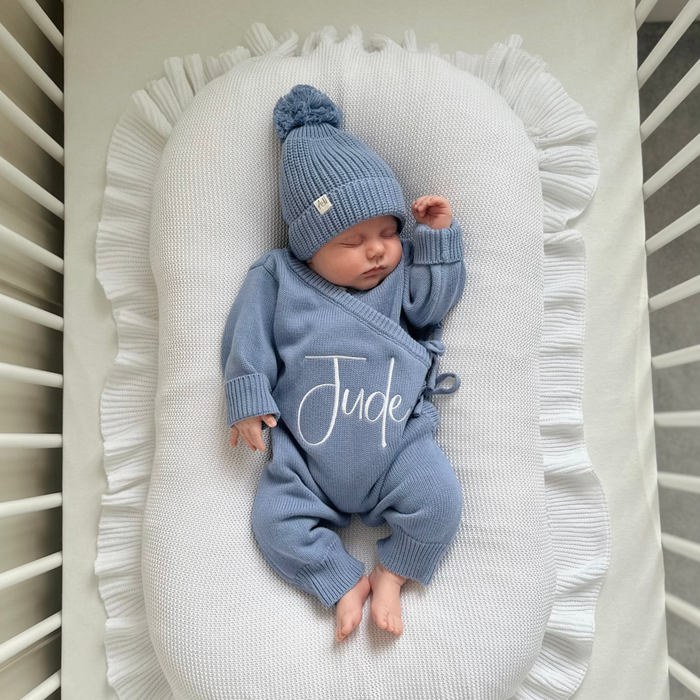 Blue long romper with matching pom-pom beanie hat, 'Jude' script on chest.