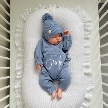 Blue long romper with matching pom-pom beanie hat, 'Jude' script on chest.