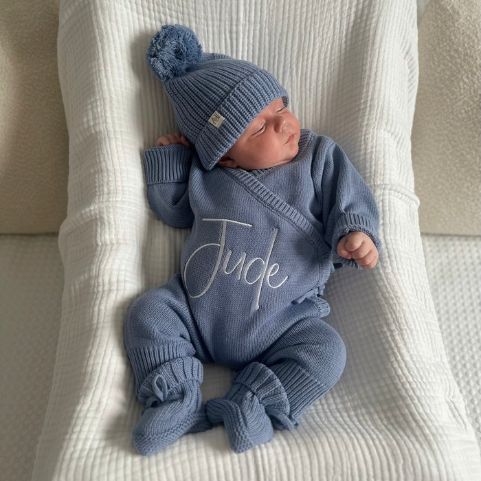Blue long romper set with matching knit hat, 'Jude' script on front.