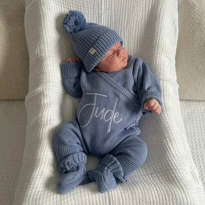 Blue long romper set with matching knit hat, 'Jude' script on front.