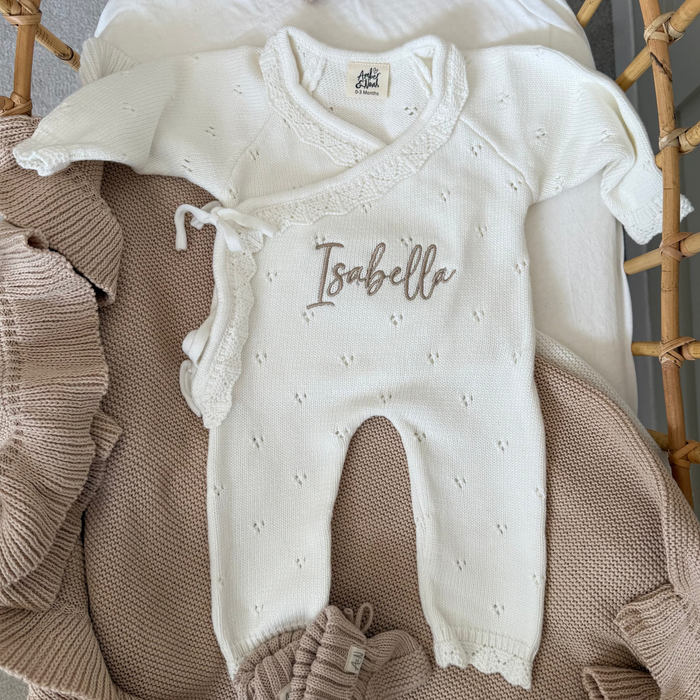 White pointelle kimono romper with front tie waist and embroidered “Isabella” name detail.
