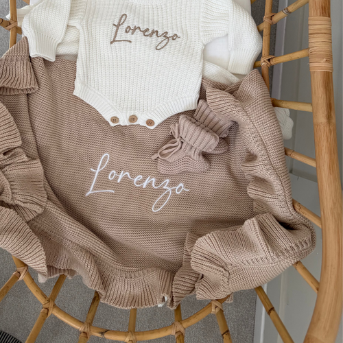 Beige knit personalised blanket with frill trim, ribbon bow and 'Lorenzo' on front