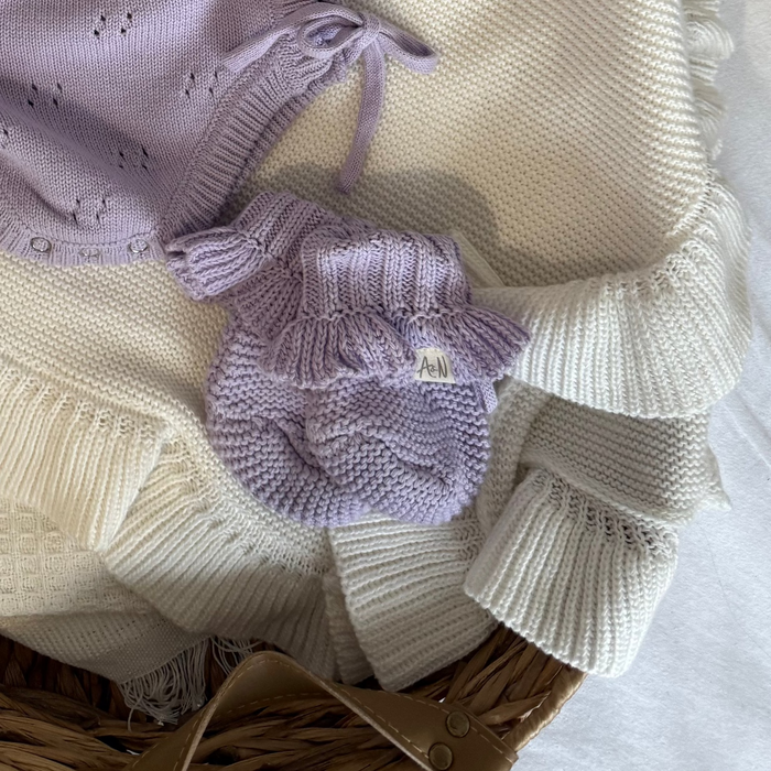 Lilac knitted baby booties with frilled cuffs and small logo patch