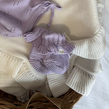Lilac knitted baby booties with frilled cuffs and small logo patch