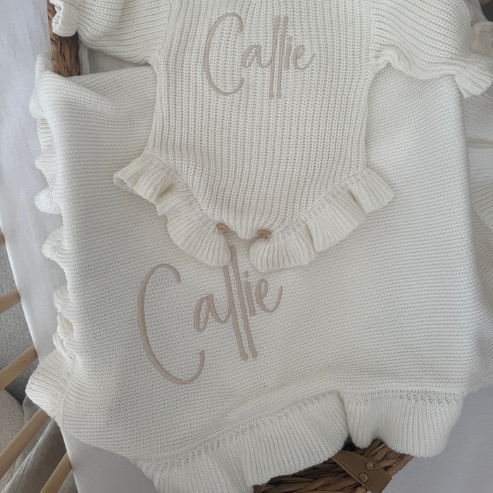 Personalized frill baby blanket with 'Callie' embroidery and textured knit surface