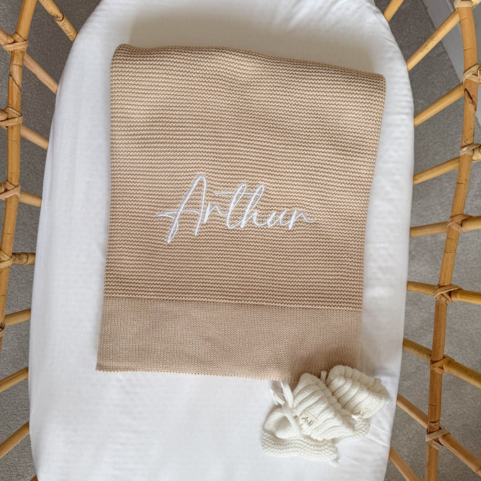 Baby beige knit blanket with embroidered name 'Arthu' and white tied corner trim