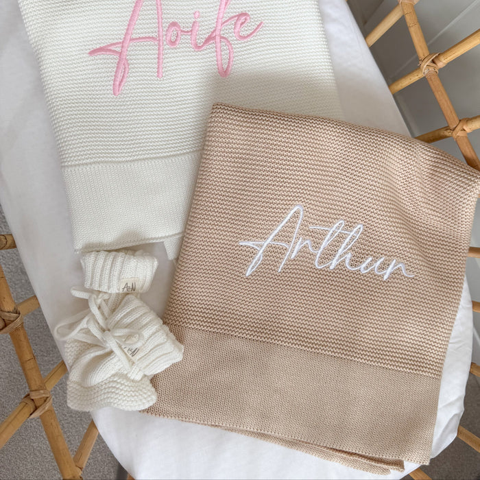Baby beige knit blanket with embroidered name 'Arthu' and white tied corner detail