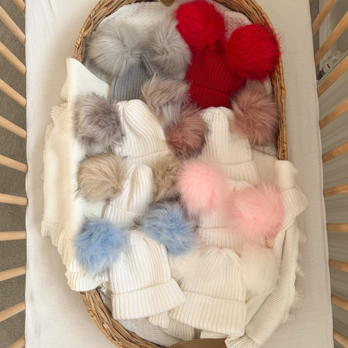 Baby knit double pom hat in a basket, cream beanie with grey, red and pink pom poms