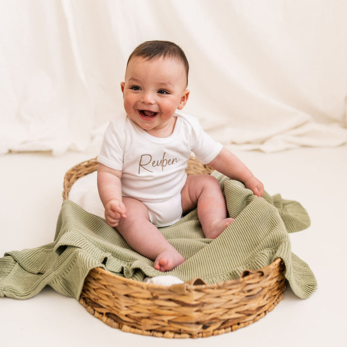 Personalised script baby vest, white bodysuit with brown Reuben chest print