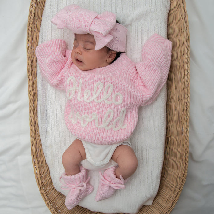 Baby pink chunky knit jumper with "hello world" lettering, ribbed sleeves and hem