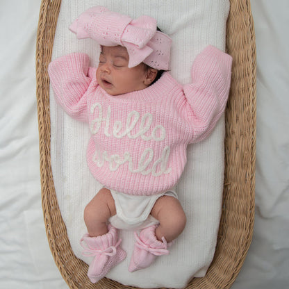 Baby pink chunky knit jumper with "hello world" lettering, ribbed sleeves and hem