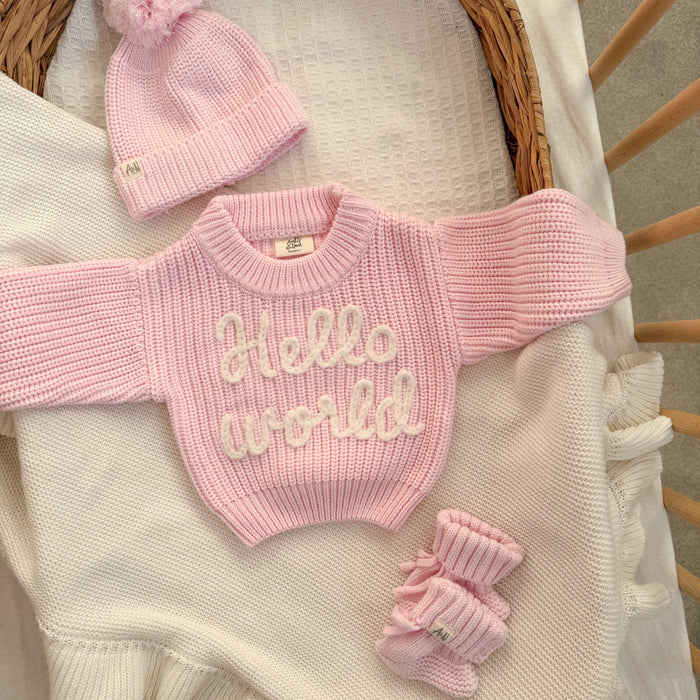 Baby pink chunky knit jumper with "hello world" text, ribbed crew neck and cuffs