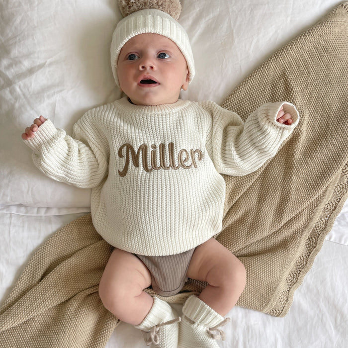 Baby chunky knitted jumper, off-white, with brown 'Miller' script on front