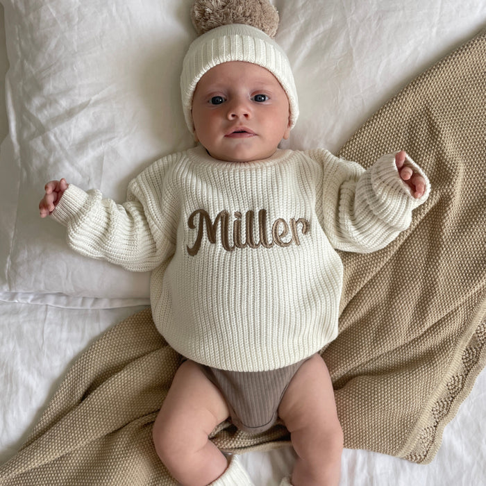 Baby chunky knit jumper with off-white ribbed cuffs and 'Miller' script
