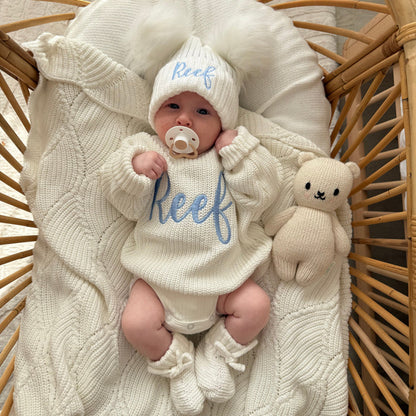Baby knitted jumper and hat bundle in white with script 'Reef' and bunny plush