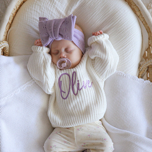 Newborn white chunky knit jumper with Nive script, mauve hat and cuffs