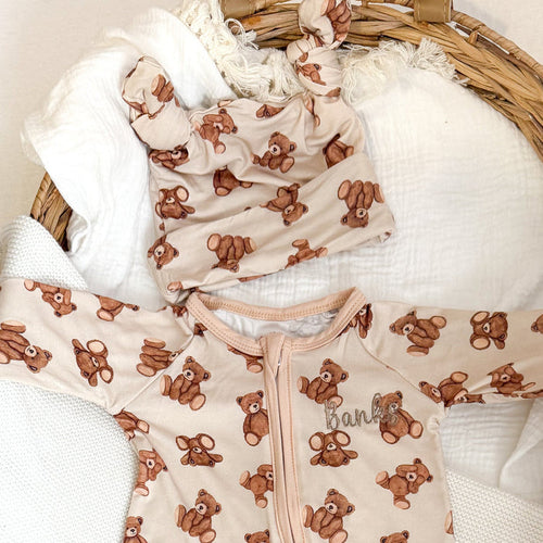 Bear baby hat, cream with brown teddy-bear print and front zipper; hood with soft trim