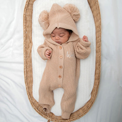 Beige button-front knit romper with hood and two-pom beanie hat for baby