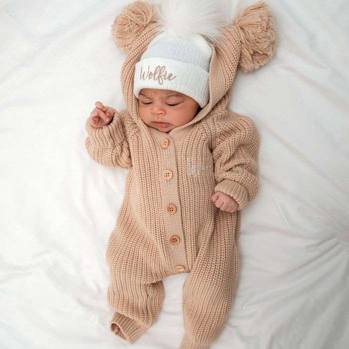 Beige knit romper with hood and pom beanie hat, beanie embroidered 'Wolffie'