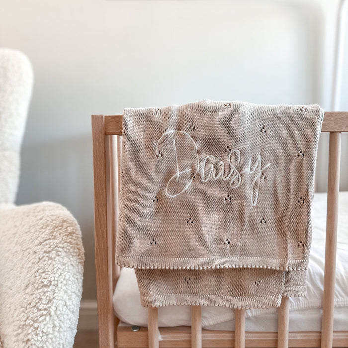 Beige pointelle baby knit blanket with embroidered name and small dot pattern