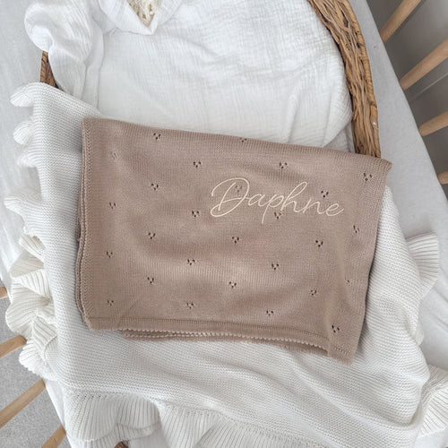 Beige baby knit blanket with pointelle pattern and embroidered “Daphne”