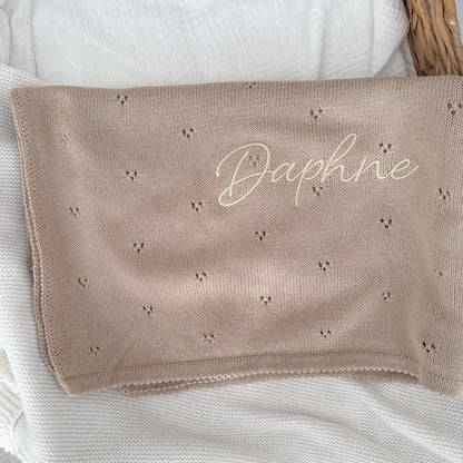 Beige baby knit blanket close-up, embroidered “Daphne” with tiny motifs