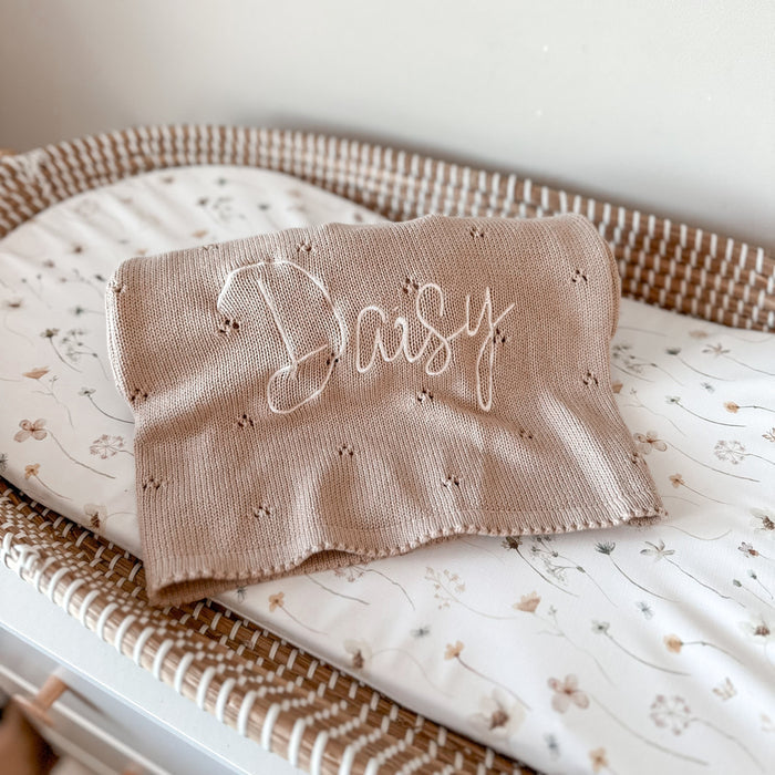 Beige pointelle baby knit blanket with cursive 'Baby' embroidery and scalloped edge