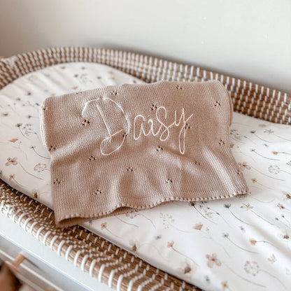 Beige pointelle baby knit blanket with cursive 'Baby' embroidery and scalloped edge