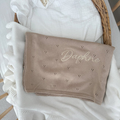Beige baby knit blanket with embroidered “Daphne” and small scattered motifs