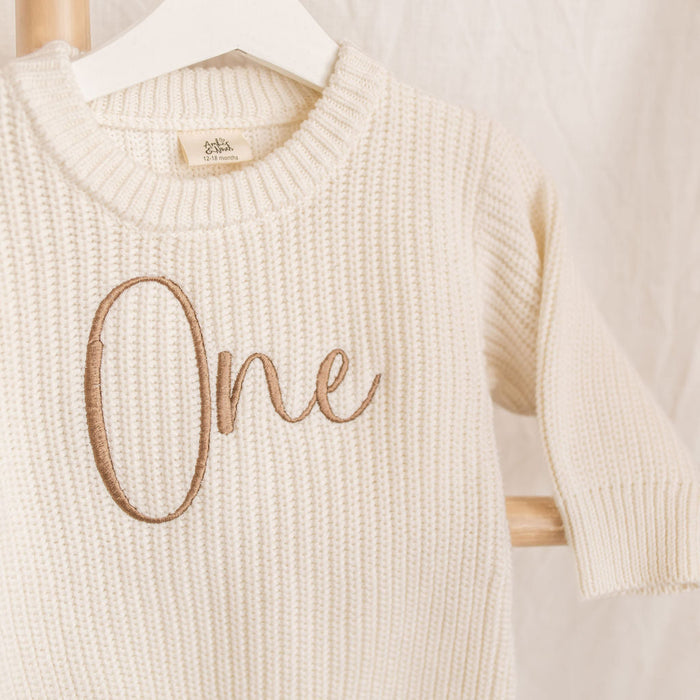 Personalised knitted romper, cream knit with 'One' embroidery on front, long sleeves