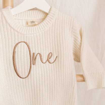 Personalised knitted romper, cream knit with 'One' embroidery on front, long sleeves