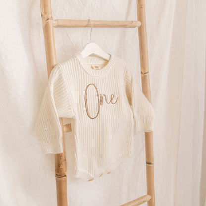 Knitted romper, cream with 'One' script on chest, crew neck, long sleeves