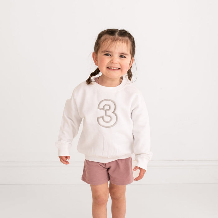 White crewneck sweater with embroidered '3' on front, long sleeves