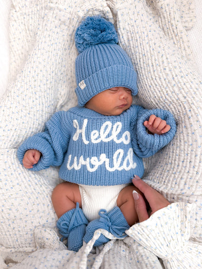 Blue knitted baby jumper with long sleeves and 'Hello world' text design