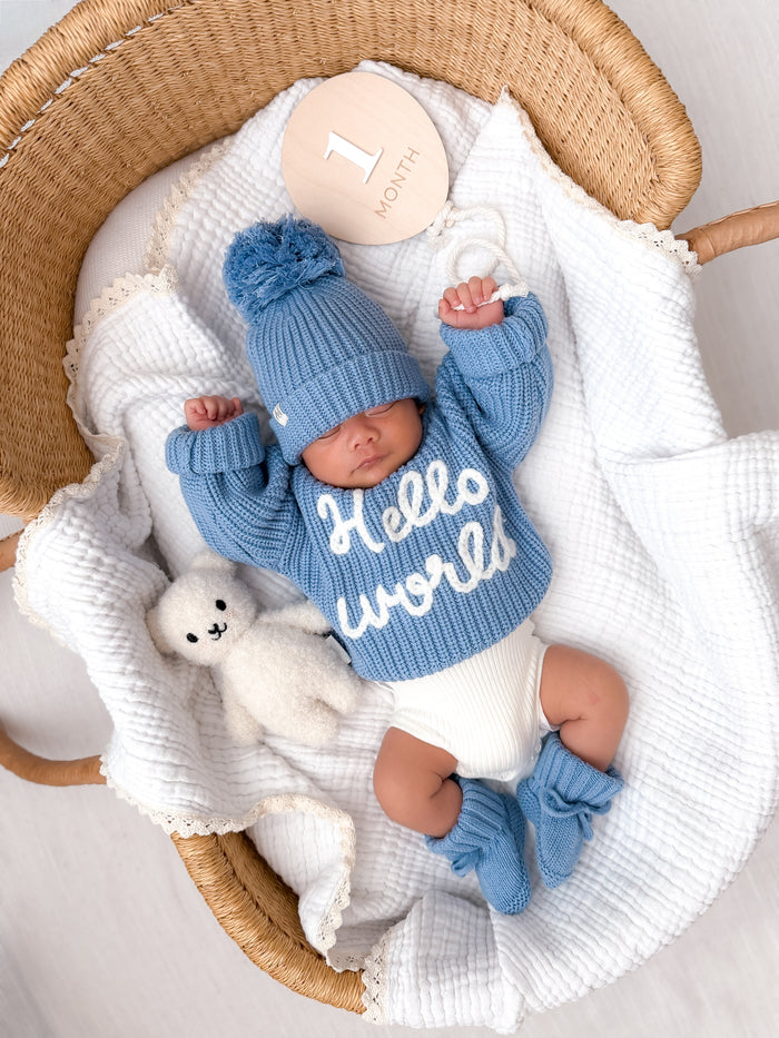 Blue ribbed knit baby jumper with 'Hello world' graphic on front
