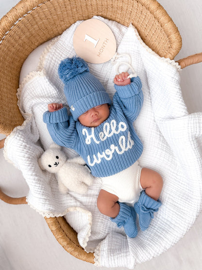 Blue ribbed knit baby jumper with 'Hello world' graphic on front