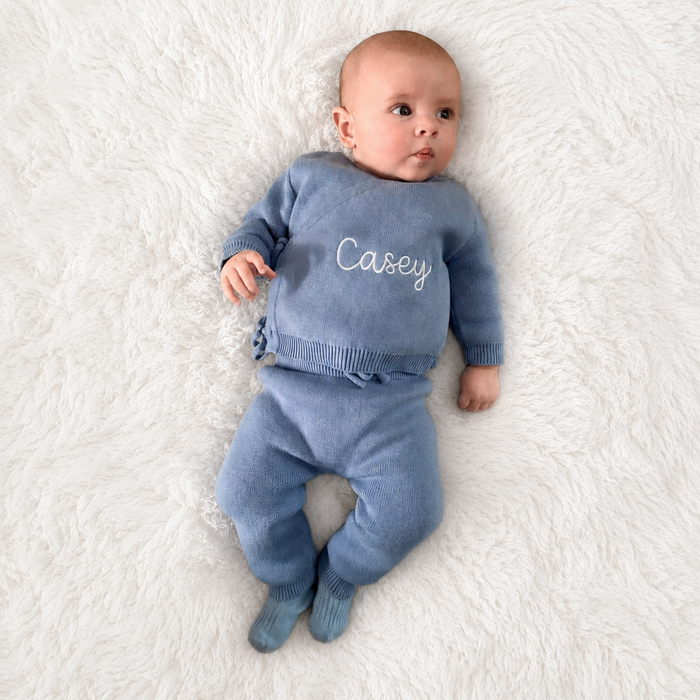 Blue knit baby kimono and trousers set on infant, Casey name on top