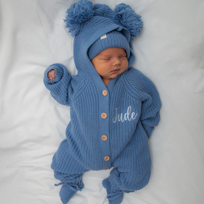 Blue knitted hooded romper with pom-pom hat, “Jude” embroidery, button front