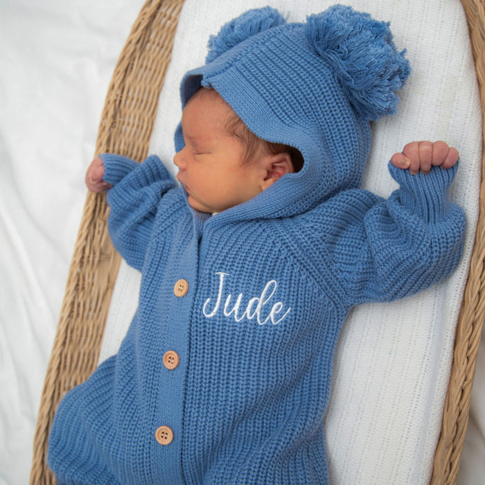 Blue knitted pom-pom hood romper, button front with “Jude” embroidery