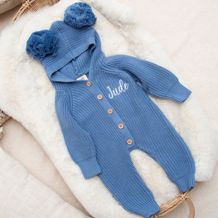 Blue knitted romper with pom-pom hood, “Jude” name, button front, long sleeves