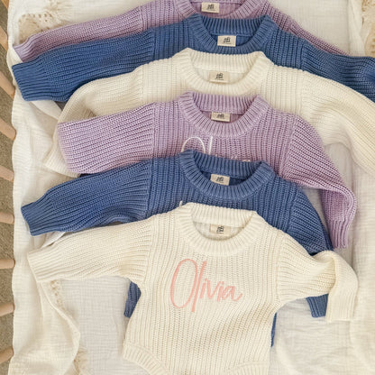 Blue knitted romper with cream and purple options, round neck and long sleeves