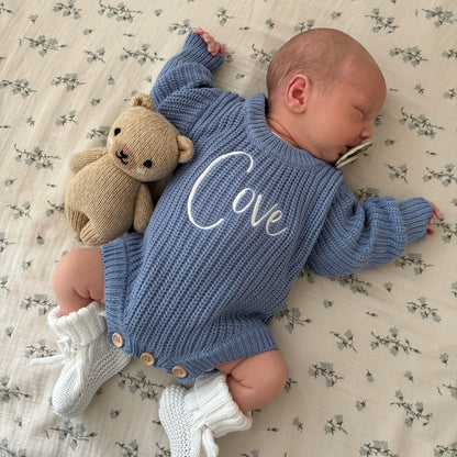 Blue knitted romper with white embroidered “Olive”, long sleeves and teddy plush