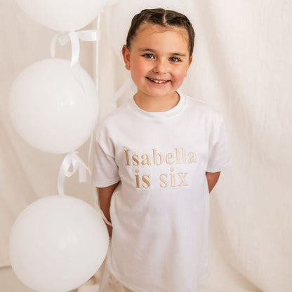Kids white T-shirt with “Isabella is six” front print