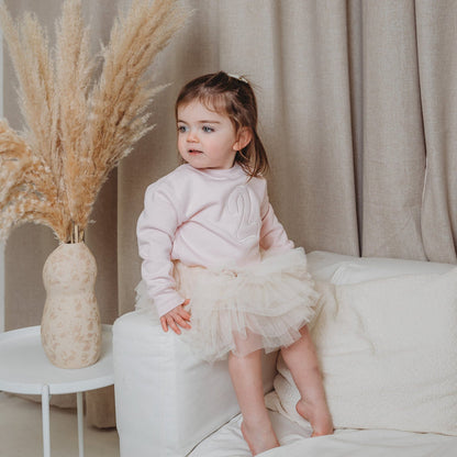 Light pink kids sweater with embroidered number on the front, long sleeves