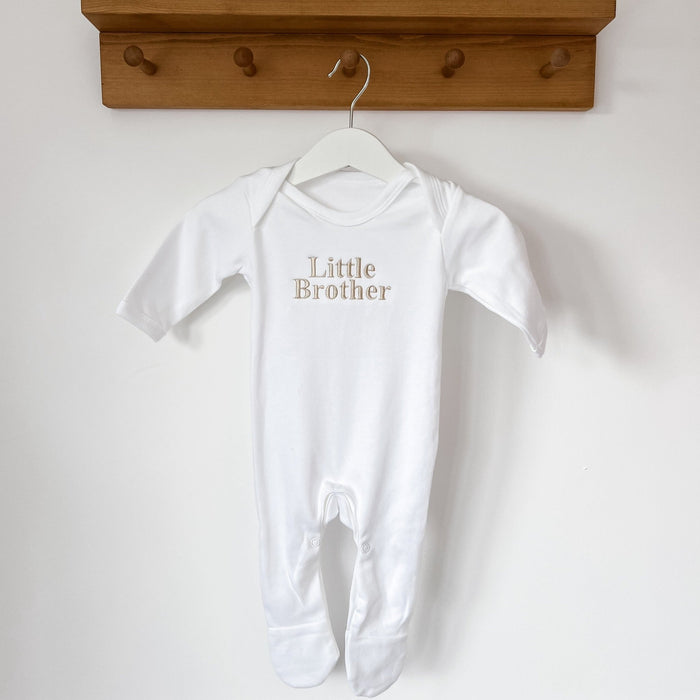 White short-sleeve baby sleepsuit with footed legs and 'Little Brother' print