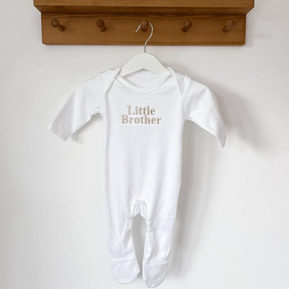 White short-sleeve baby sleepsuit with footed legs and 'Little Brother' print
