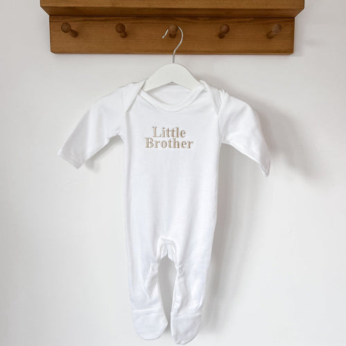 White short-sleeve baby sleepsuit with footed legs and 'Little Brother' print
